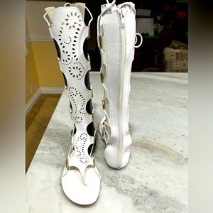 White flat knee high gladiator sandal with stretchy panels